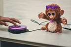 Purple switch being used to move a toy monkey
